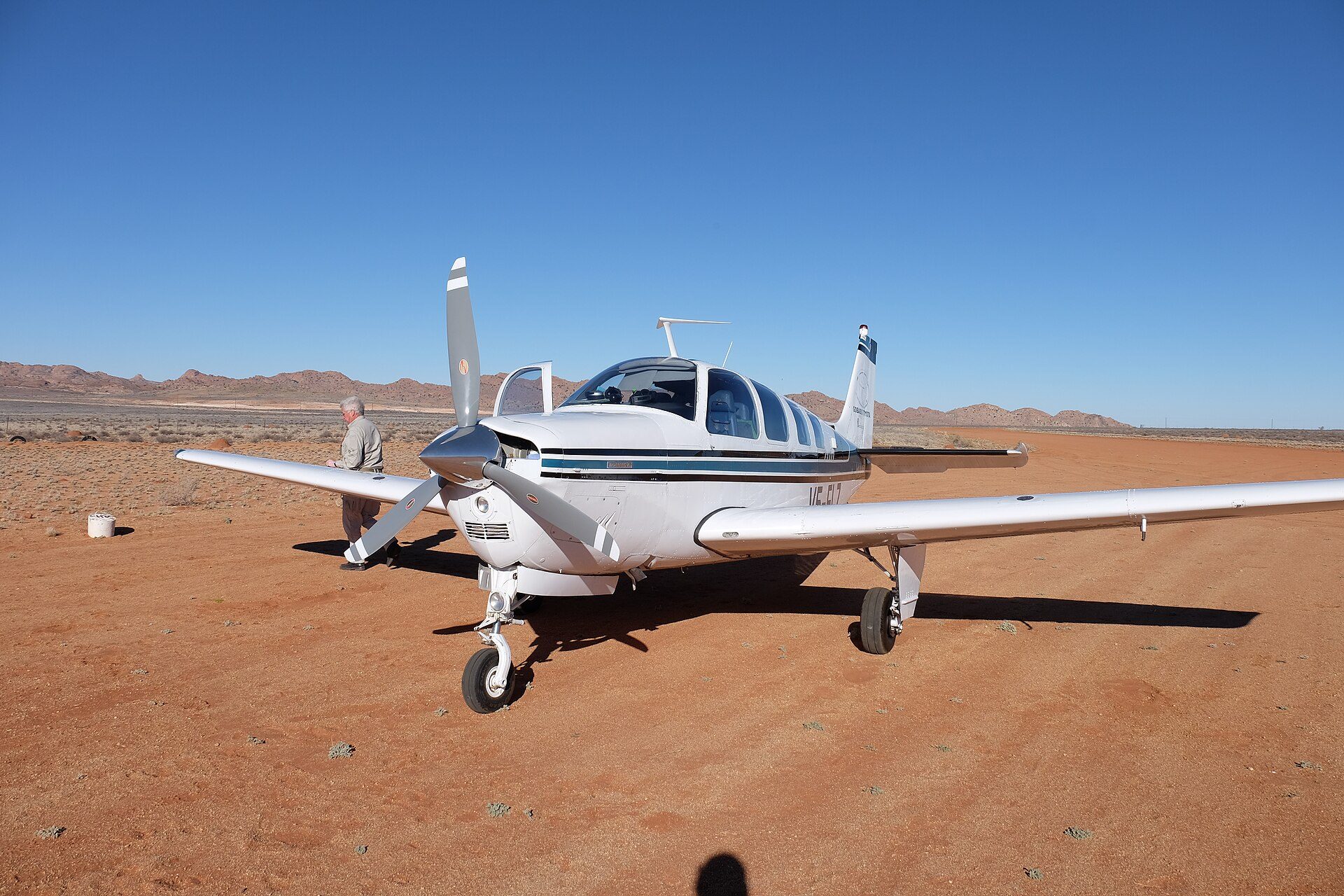 Single-engine piston airplane on a desert ramp